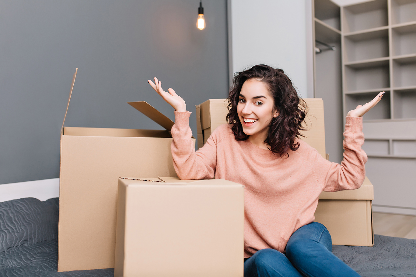 image of woman sitting on the floor with moving boxes